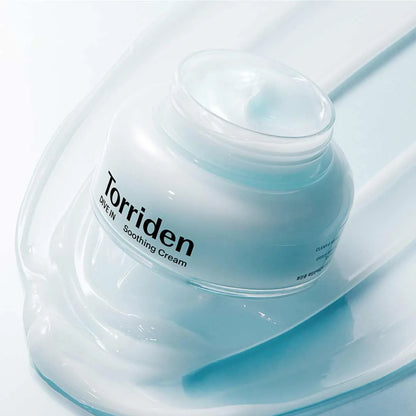 Torriden Dive In Soothing Cream jar with blue cream texture on a smooth surface